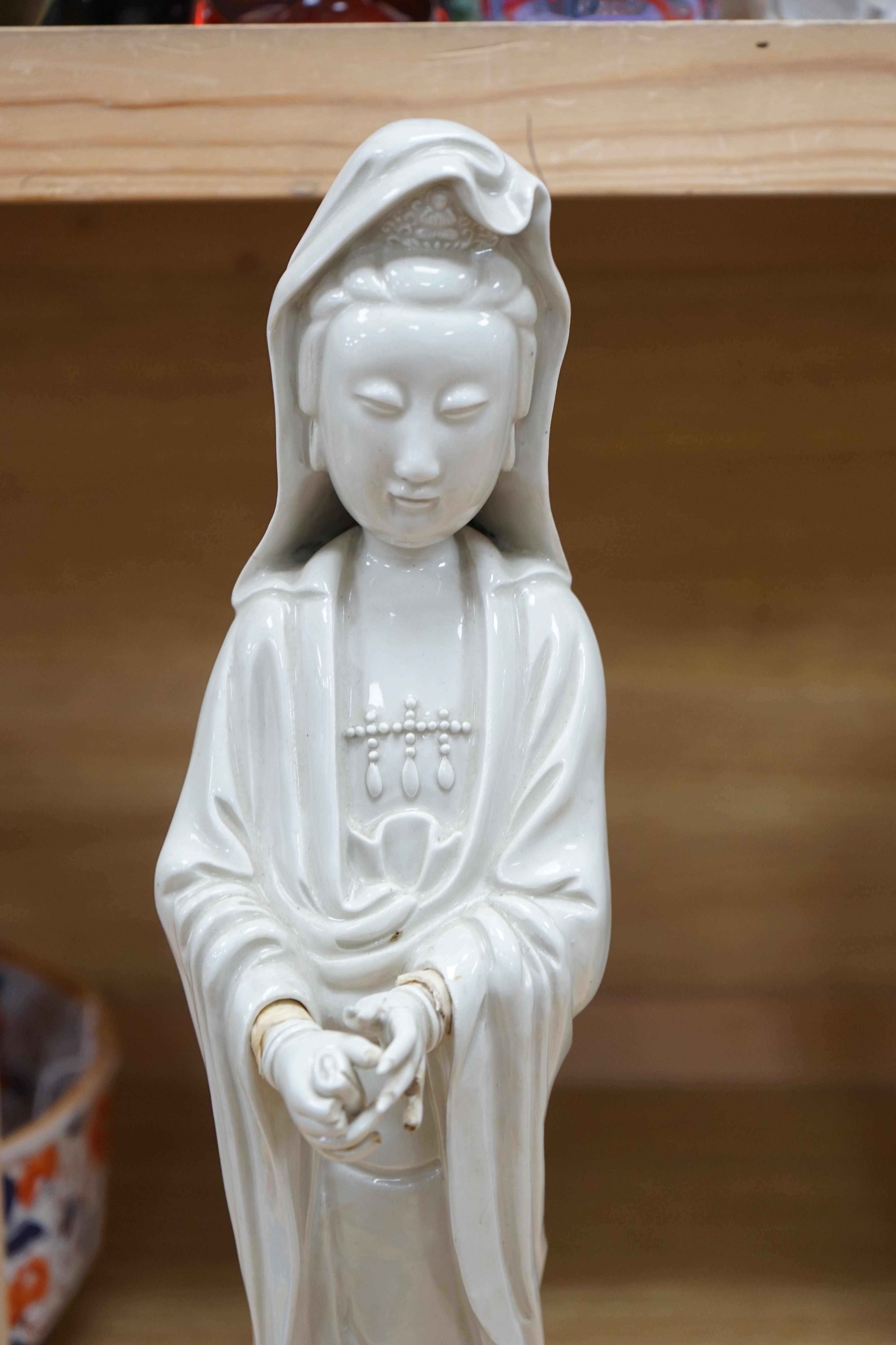 A Chinese blanc de chine figure of Guanyin, 45cm high. Condition - poor to fair, a number of fingers broken and missing